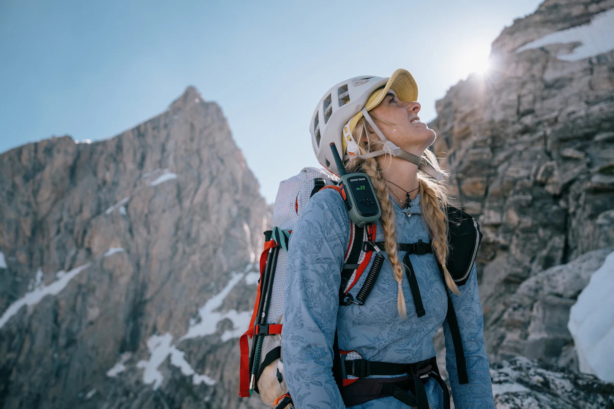 Person with a backpack on a mountain peak