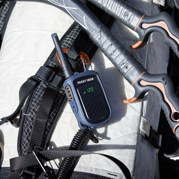 Ice axe set with a walkie-talkie on a white backpack