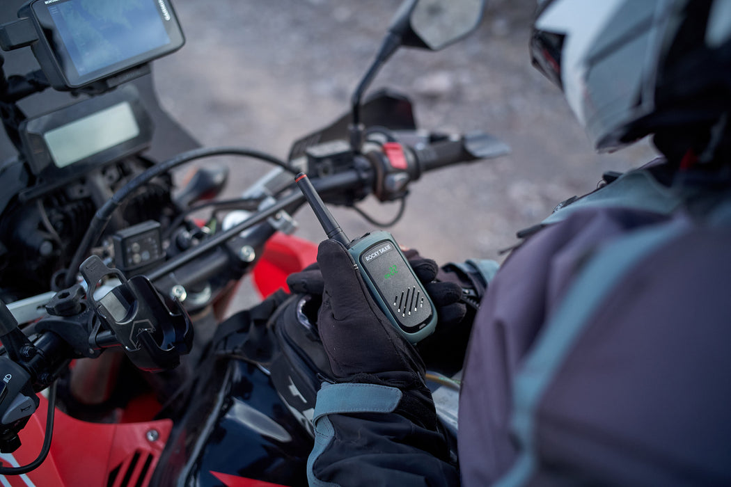 Person on a motorcycle holding an Expedition Radio