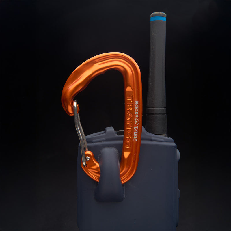 Orange carabiner attached to a blue walkie talkie with a black background