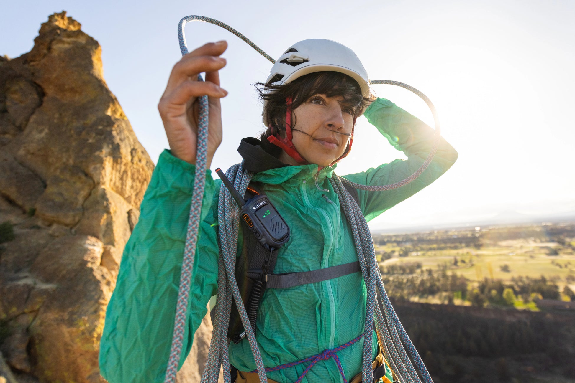 Climber on ledge with rope and Rocky Talkie radio