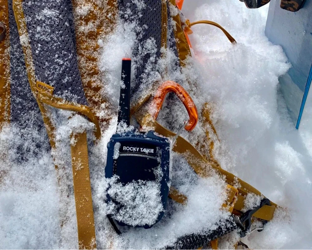 Backpack with climbing equipment on a snowy ground