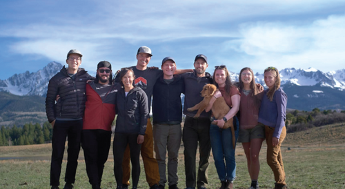 Team photo with mountains in the background